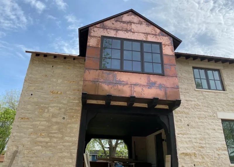 Copper metal panel facade on a stone building for Skylight Installation in Leon Valley