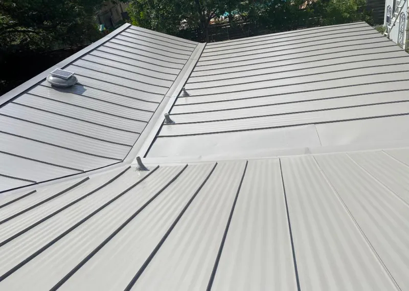 Solar attic fan installed on a metal roof for Roof Ventilation in Leon Valley